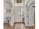 Bright foyer with wood-look flooring, high ceilings, and natural light beaming through the front door window at 1028 15Th Ne St, Winter Haven, FL 33881