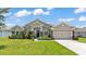 Charming single-story home features lush landscaping, a two-car garage, and attractive stone accents at 1028 15Th Ne St, Winter Haven, FL 33881