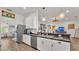 Open kitchen with stainless steel appliances, bar-style countertop, and views into the living area at 1028 15Th Ne St, Winter Haven, FL 33881