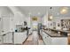 Modern galley kitchen with white cabinets, stainless steel appliances, and long countertops at 1028 15Th Ne St, Winter Haven, FL 33881