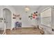 Bright playroom features wood-look flooring, white walls, and modern chandelier at 1028 15Th Ne St, Winter Haven, FL 33881