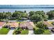 Aerial view of a single Gathering home with mature trees, lush lawns, and access to a tranquil lake at 104 Morning Glory Cir, Winter Haven, FL 33884