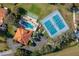 Overhead view of community clubhouse, pool, tennis courts, and parking at 104 Morning Glory Cir, Winter Haven, FL 33884