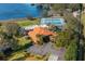 An aerial view of the community clubhouse, swimming pool, tennis courts, parking, and stunning lake views at 104 Morning Glory Cir, Winter Haven, FL 33884