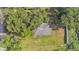 Aerial top-down view of a home surrounded by a large green lawn and trees at 1050 Reynolds Rd, Lakeland, FL 33801
