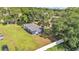 Aerial view shows home situated on a large lot and is surrounded by lush trees and greenery at 1050 Reynolds Rd, Lakeland, FL 33801