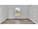 Cozy bedroom with a window, closet, and stylish wood-look flooring at 1050 Reynolds Rd, Lakeland, FL 33801