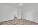 A simple bedroom with hard surface floors, fresh white walls and a ceiling fan at 1050 Reynolds Rd, Lakeland, FL 33801