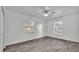 Spacious bedroom with wood-look floors and two windows with a ceiling fan at 1050 Reynolds Rd, Lakeland, FL 33801