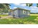 Back of the house on a well-maintained lot with lush grass and white trim windows at 1050 Reynolds Rd, Lakeland, FL 33801