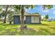 Exterior view of the home, showcasing its neat design and the surrounding greenery at 1050 Reynolds Rd, Lakeland, FL 33801
