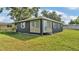 Well-kept home with a fresh exterior, complemented by a lush green lawn and manicured landscaping at 1050 Reynolds Rd, Lakeland, FL 33801