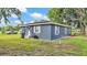View of the side and back of the house with a well-maintained grassy lawn at 1050 Reynolds Rd, Lakeland, FL 33801