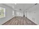 Bright and open living room with new flooring, providing a clear view to other rooms at 1050 Reynolds Rd, Lakeland, FL 33801