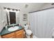 A cozy bathroom features a toilet, a sink with vanity, and a shower with a curtain at 114 Ed Padgett Rd, Lakeland, FL 33809