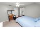 This bedroom is furnished with a single bed, study desk, a window, and ceiling fan at 114 Ed Padgett Rd, Lakeland, FL 33809