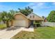 Charming single-Gathering home featuring a well-manicured lawn, two-car garage, and an inviting front porch at 114 Ed Padgett Rd, Lakeland, FL 33809
