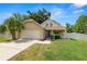 Charming single-Gathering home featuring a well-manicured lawn, two-car garage, and an inviting front porch at 114 Ed Padgett Rd, Lakeland, FL 33809