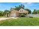 Charming single-Gathering home featuring a well-manicured lawn, two-car garage, and an inviting front porch at 114 Ed Padgett Rd, Lakeland, FL 33809