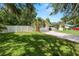 Single-Gathering home with a lush lawn, long driveway, two-car garage and white privacy fence at 114 Ed Padgett Rd, Lakeland, FL 33809
