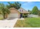 Charming single-Gathering home featuring a well-manicured lawn, two-car garage, and an inviting front porch at 114 Ed Padgett Rd, Lakeland, FL 33809