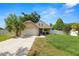 Charming single-Gathering home featuring a well-manicured lawn, two-car garage, and an inviting front porch at 114 Ed Padgett Rd, Lakeland, FL 33809