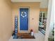 Inviting front porch with cozy seating, decorative pillows, patriotic decor and colorful striped rug at 114 Ed Padgett Rd, Lakeland, FL 33809