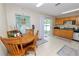 Eat-in kitchen features wooden table and chairs next to sliding glass door with backyard views at 114 Ed Padgett Rd, Lakeland, FL 33809