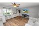 Bright living room with hardwood floors, comfortable seating, television and ample natural light at 114 Ed Padgett Rd, Lakeland, FL 33809