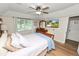 The primary bedroom boasts hard wood floors, a mounted television, and natural light at 114 Ed Padgett Rd, Lakeland, FL 33809