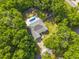 Aerial view of a home with an in-ground pool, patio area, fenced backyard, and mature landscaping at 13 Count Fleet Dr, Ocala, FL 34482