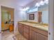 Bathroom featuring double sinks with granite countertops, and access to bedroom at 13 Count Fleet Dr, Ocala, FL 34482