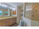 Primary bathroom featuring double vanity, granite counters, and a beautifully tiled shower stall at 13 Count Fleet Dr, Ocala, FL 34482