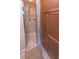 Bathroom featuring a glass shower, a wooden cabinet, and neutral tiled flooring at 13 Count Fleet Dr, Ocala, FL 34482