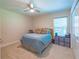 Bedroom with tan carpet, a ceiling fan, and a bed with blue bedding and decorative pillows at 13 Count Fleet Dr, Ocala, FL 34482
