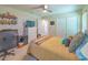 Bedroom with tan carpet, a ceiling fan, and a bed with a patterned blanket and decorative pillows at 13 Count Fleet Dr, Ocala, FL 34482