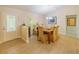 Formal dining room with elegant chandelier, six chairs, and view of the exterior, filled with natural light at 13 Count Fleet Dr, Ocala, FL 34482