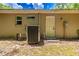 Exterior view of utility hook ups, back door, and external AC unit at 13 Count Fleet Dr, Ocala, FL 34482