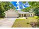 Charming single-story home with a well-manicured lawn, attached garage and a welcoming entrance at 13 Count Fleet Dr, Ocala, FL 34482