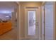 Hallway with view to a living space and an exterior door with blinds at 13 Count Fleet Dr, Ocala, FL 34482