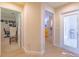 Hallway with view to multiple rooms and a bright, neutral color palette at 13 Count Fleet Dr, Ocala, FL 34482