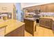 Modern kitchen featuring stainless steel appliances, an island, granite countertops, and wooden cabinetry at 13 Count Fleet Dr, Ocala, FL 34482