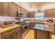 Stylish kitchen with stainless steel appliances, granite countertops, tile backsplash, and ample cabinet space at 13 Count Fleet Dr, Ocala, FL 34482