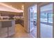 Modern kitchen with stainless appliances, granite countertops and light colored tiled floors at 13 Count Fleet Dr, Ocala, FL 34482
