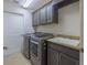 Convenient laundry room with front load washer and dryer, utility sink, and ample storage at 13 Count Fleet Dr, Ocala, FL 34482