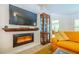 Living room featuring a modern fireplace, large flat screen TV, and stylish display cabinet at 13 Count Fleet Dr, Ocala, FL 34482