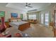 Spacious main bedroom suite with tray ceiling, ceiling fan, and access to pool area at 13 Count Fleet Dr, Ocala, FL 34482