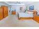 Comfortable main bedroom suite with a plush bed, carpeted floors, and walk in closet at 13 Count Fleet Dr, Ocala, FL 34482