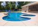 Sparkling pool with spa and rock features, surrounded by a large patio at 13 Count Fleet Dr, Ocala, FL 34482