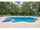 Sparkling pool with spa and waterfall features, surrounded by a spacious patio at 13 Count Fleet Dr, Ocala, FL 34482